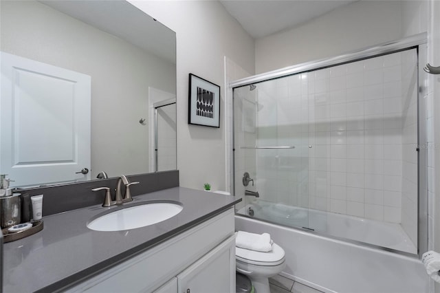 full bathroom featuring tile patterned floors, vanity, bath / shower combo with glass door, and toilet