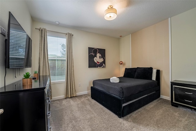 carpeted bedroom featuring a textured ceiling