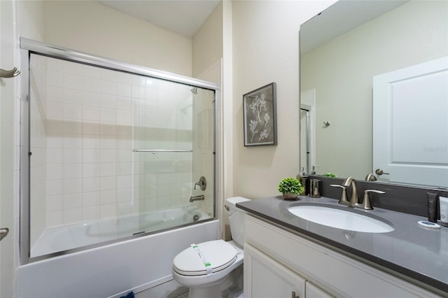 full bathroom with vanity, toilet, and enclosed tub / shower combo