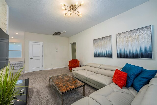 carpeted living room featuring a textured ceiling and an inviting chandelier