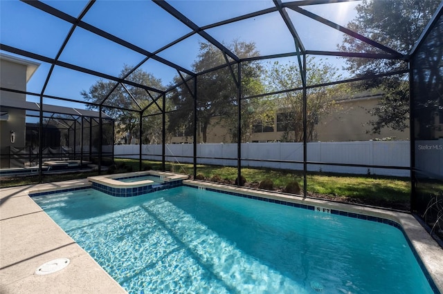 view of swimming pool featuring glass enclosure and an in ground hot tub