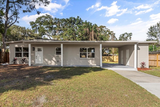 view of front of property with a front yard and a carport