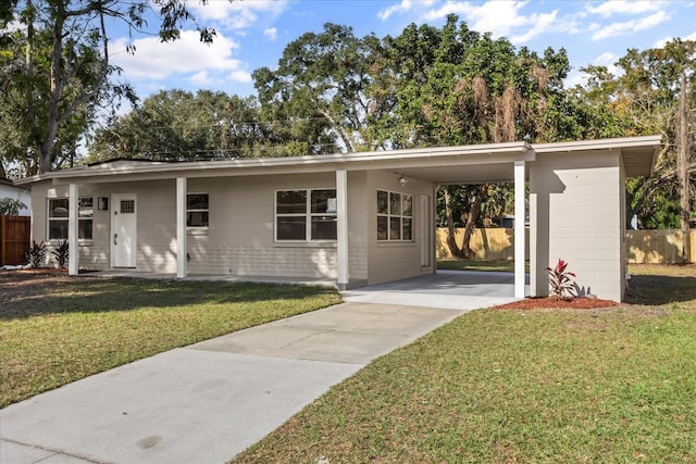 ranch-style house with a carport and a front yard