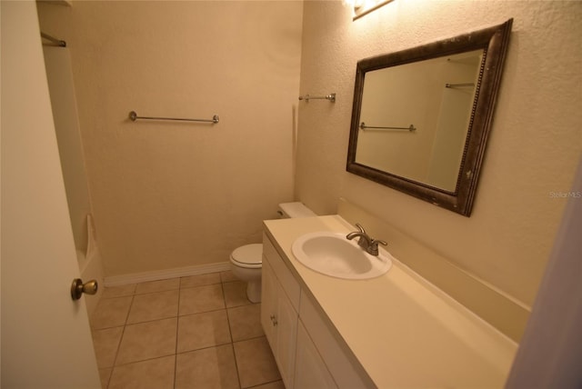 bathroom featuring toilet, vanity, and tile patterned floors