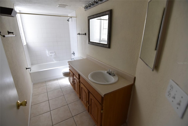 full bathroom featuring tile patterned flooring, vanity, toilet, and tiled shower / bath