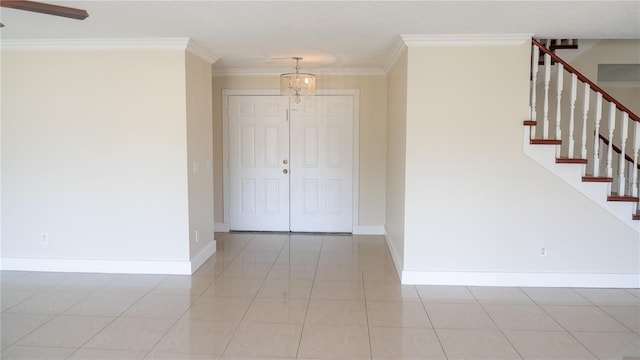 tiled foyer entrance featuring crown molding and a notable chandelier