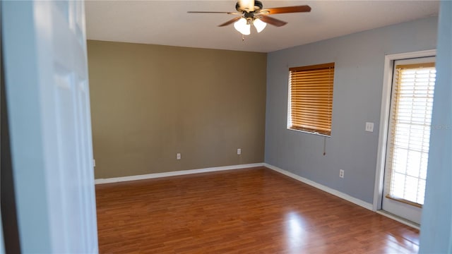 empty room with ceiling fan and wood-type flooring