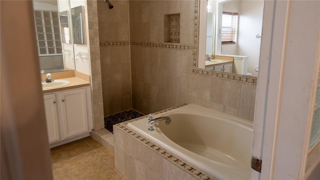 bathroom with vanity, tile patterned flooring, and plus walk in shower