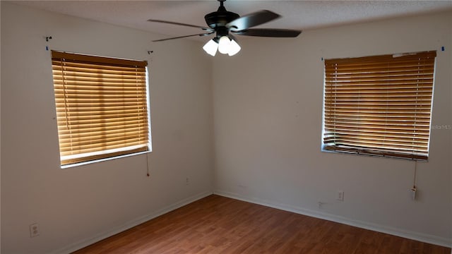 unfurnished room featuring hardwood / wood-style flooring, ceiling fan, and a textured ceiling