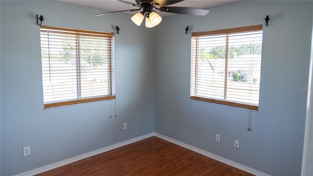 empty room featuring plenty of natural light, ceiling fan, and wood-type flooring