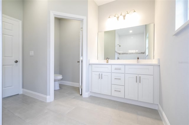 bathroom featuring tile patterned flooring, vanity, toilet, and walk in shower