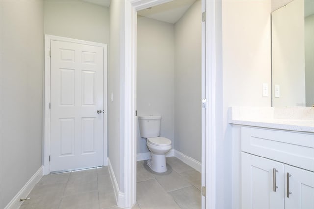 bathroom featuring tile patterned floors, vanity, and toilet