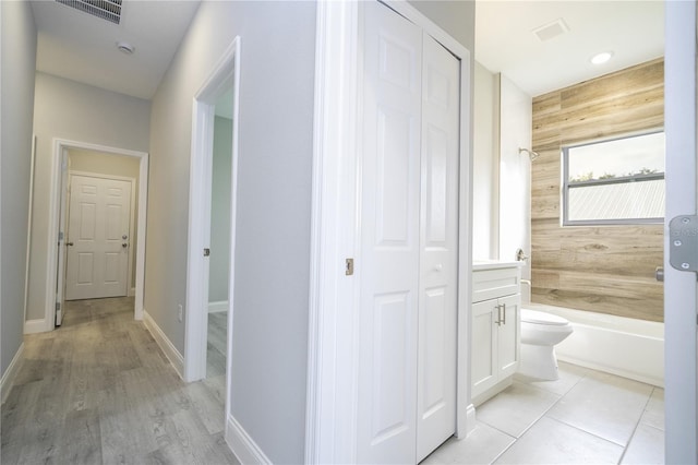 hall featuring wood walls and light hardwood / wood-style flooring