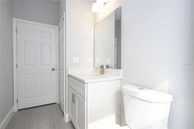 bathroom with tile patterned flooring, vanity, and toilet