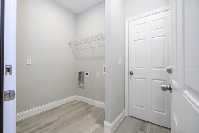 laundry room with electric dryer hookup and light hardwood / wood-style floors