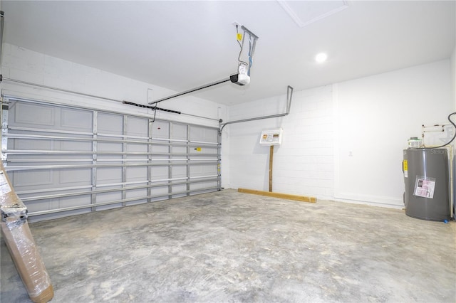 garage featuring electric water heater and a garage door opener