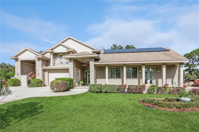 view of front of house with a porch, solar panels, a front lawn, and a garage