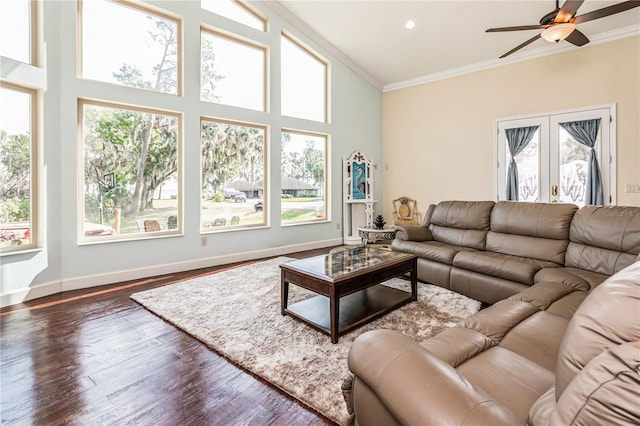 living room with dark wood-type flooring, a high ceiling, french doors, ornamental molding, and ceiling fan