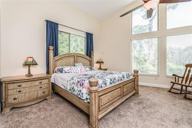 carpeted bedroom with multiple windows and ceiling fan