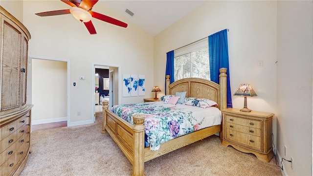 bedroom featuring ceiling fan, vaulted ceiling, and light colored carpet