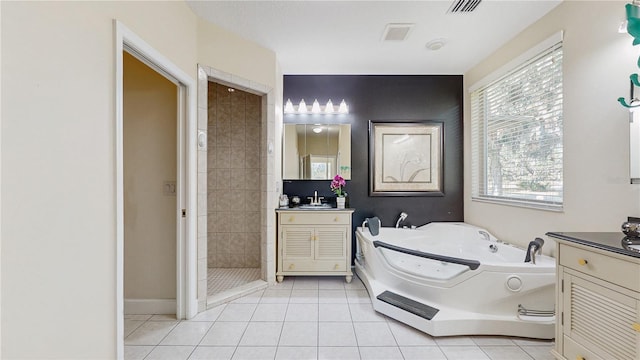 bathroom with vanity, tile patterned floors, and plus walk in shower