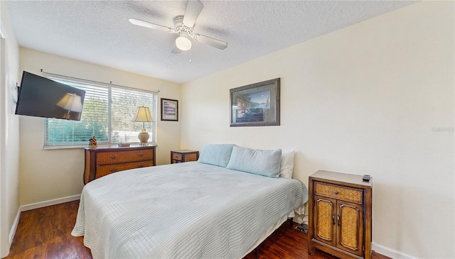 bedroom featuring dark hardwood / wood-style flooring, a textured ceiling, and ceiling fan