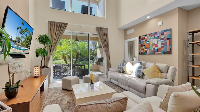 living room featuring a towering ceiling