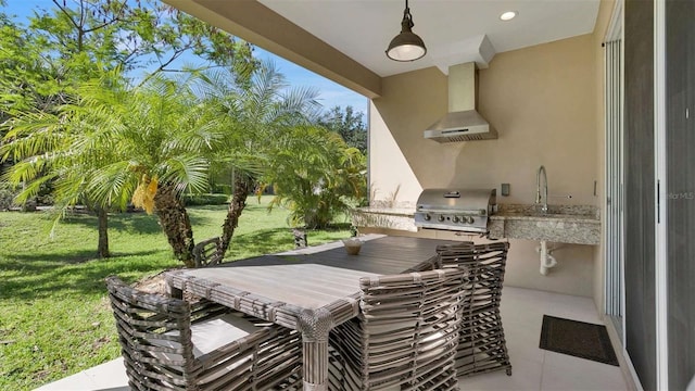 view of patio / terrace with a grill, sink, and an outdoor kitchen