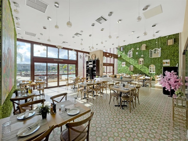 dining area featuring a wall of windows