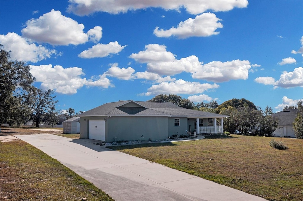 single story home featuring a front yard, covered porch, and a garage