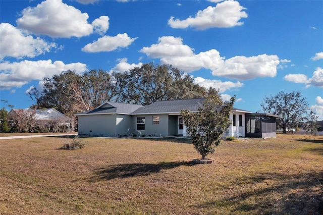 view of front of home with a front lawn and a sunroom