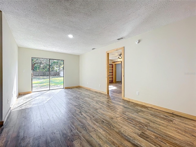 unfurnished room featuring a textured ceiling, dark hardwood / wood-style flooring, and ceiling fan