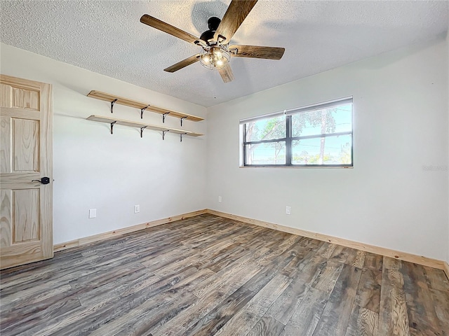 unfurnished room with dark hardwood / wood-style flooring, a textured ceiling, and ceiling fan