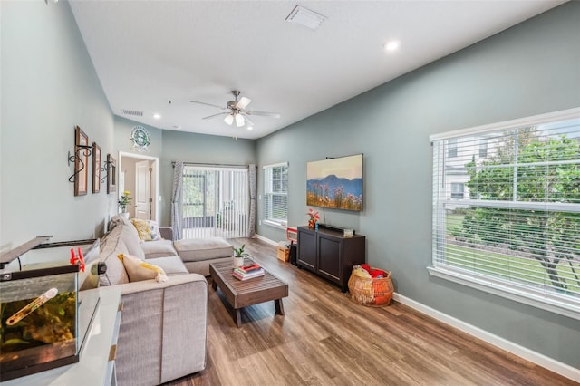 living room featuring ceiling fan and wood-type flooring