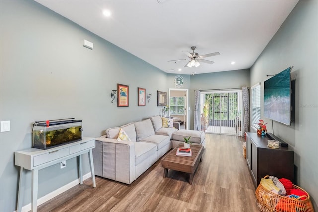 living room with ceiling fan and hardwood / wood-style floors