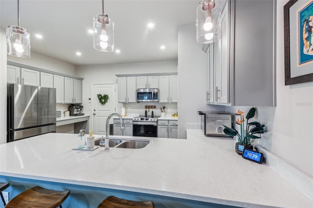 2920 Oak Park Way Apt A, Orlando, FL 32822 - kitchen featuring appliances with stainless steel finishes, a breakfast bar area, decorative light fixtures, a peninsula, and recessed lighting