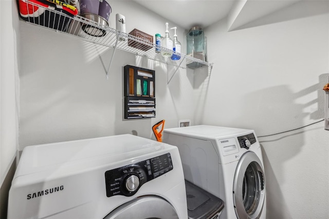 clothes washing area featuring washer and dryer