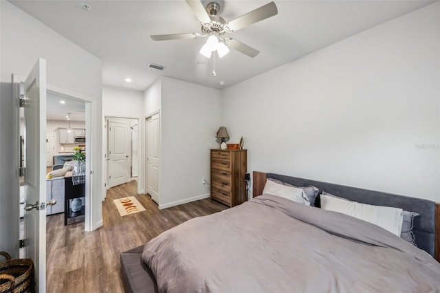 bedroom featuring ceiling fan, dark hardwood / wood-style flooring, and a closet