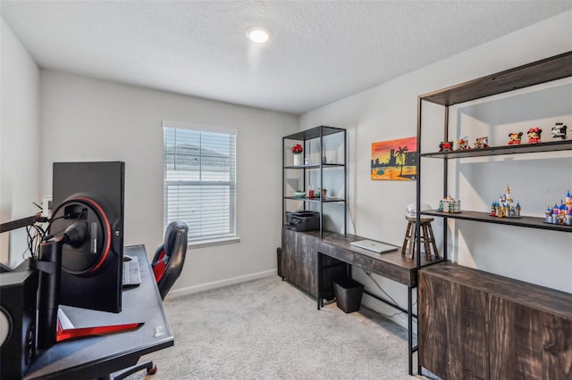 office space with a textured ceiling and light colored carpet