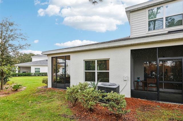 2920 Oak Park Way Apt A, Orlando, FL 32822 - back of house with a sunroom, stucco siding, and a yard