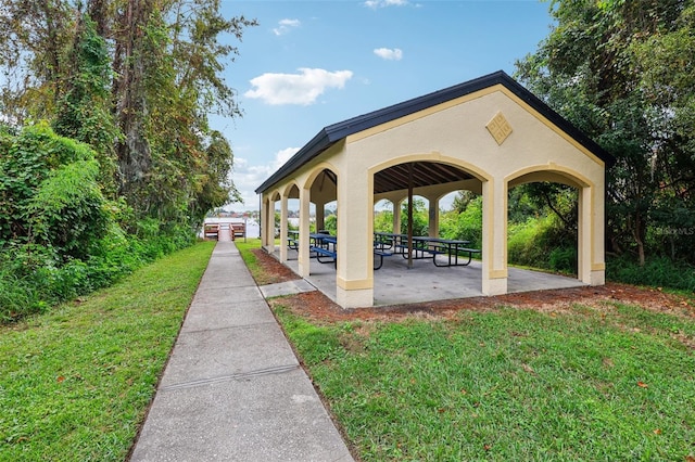 view of property's community featuring a gazebo, a yard, and a patio