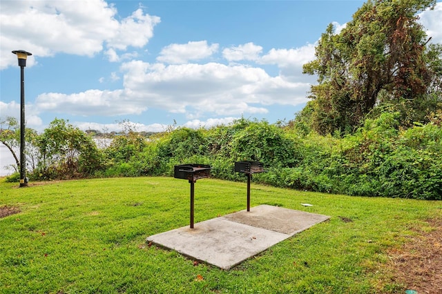 surrounding community featuring a yard and a patio