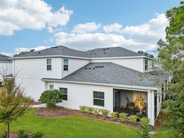 rear view of property with a lawn