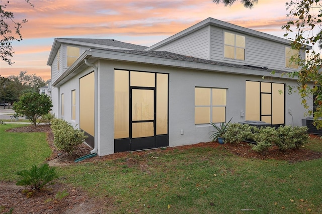 2920 Oak Park Way Apt A, Orlando, FL 32822 - back of house with a yard, a shingled roof, and stucco siding