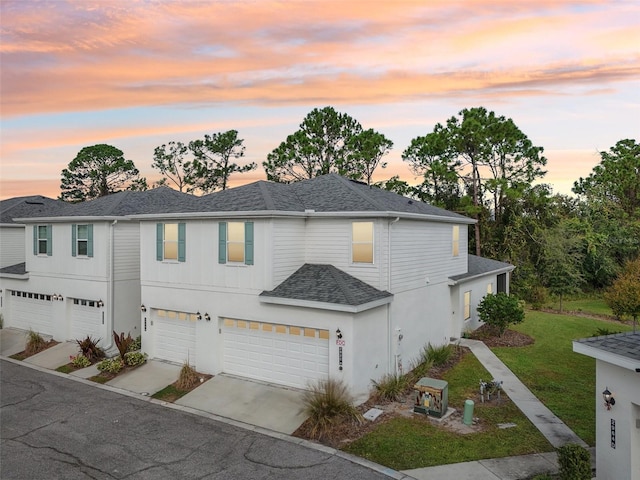 2920 Oak Park Way Apt A, Orlando, FL 32822 - view of front of property featuring an attached garage, concrete driveway, a shingled roof, a lawn, and stucco siding