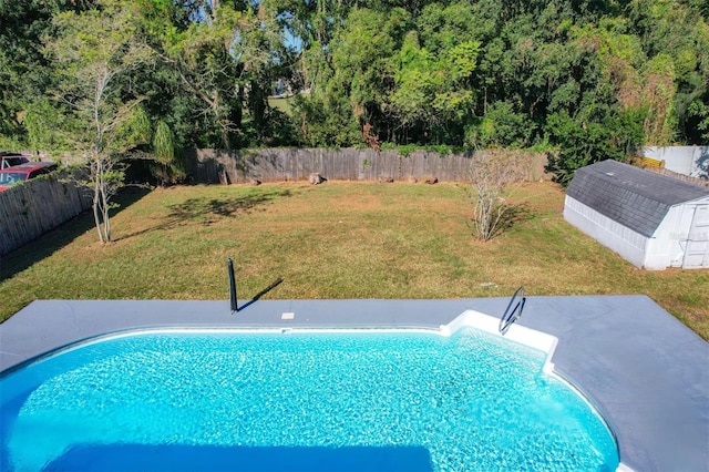 view of swimming pool featuring a yard and a shed