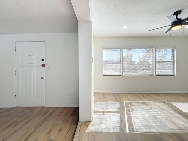 entrance foyer featuring a textured ceiling, light hardwood / wood-style floors, plenty of natural light, and ceiling fan