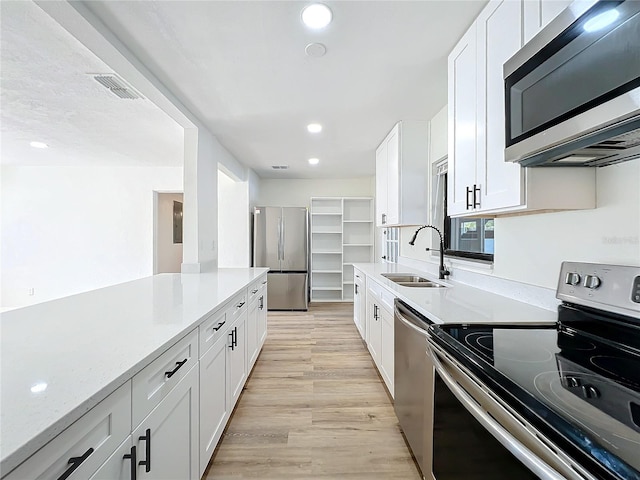 kitchen with white cabinetry, sink, and stainless steel appliances