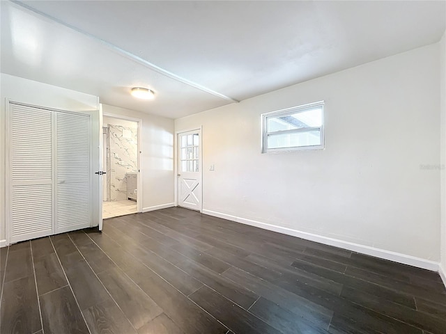 empty room featuring dark hardwood / wood-style flooring