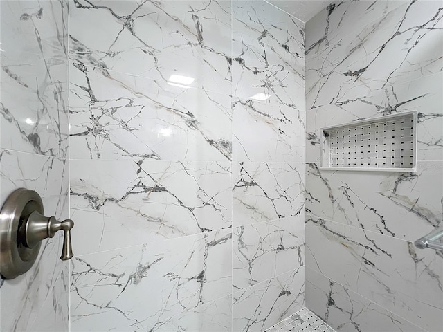 bathroom with tiled shower